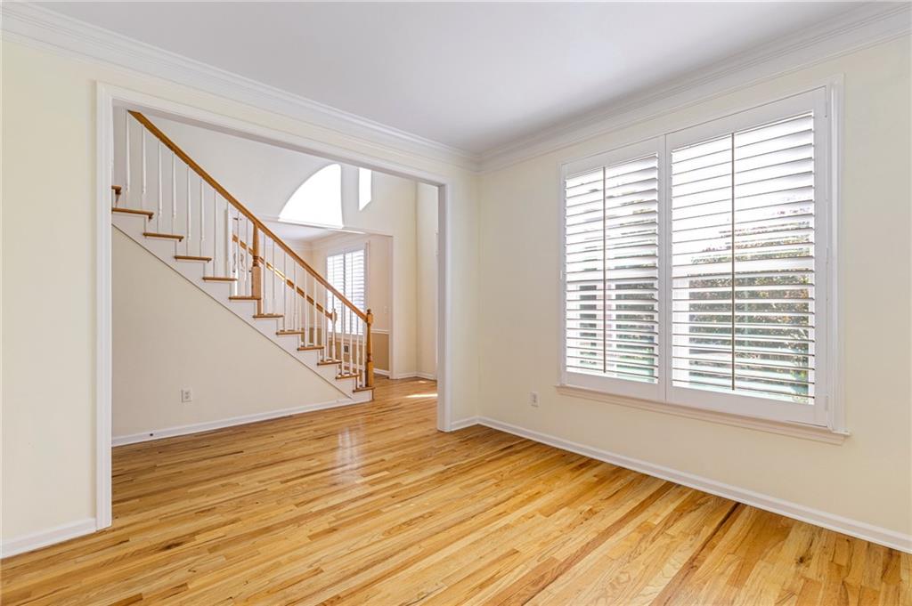 1355 Chattahoochee Run Drive Suwanee, GA 30024 - Photo 4 of 57 a view of an empty room with wooden floor and a window