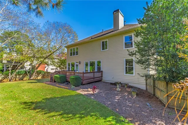 an aerial view of a house with a yard and garden