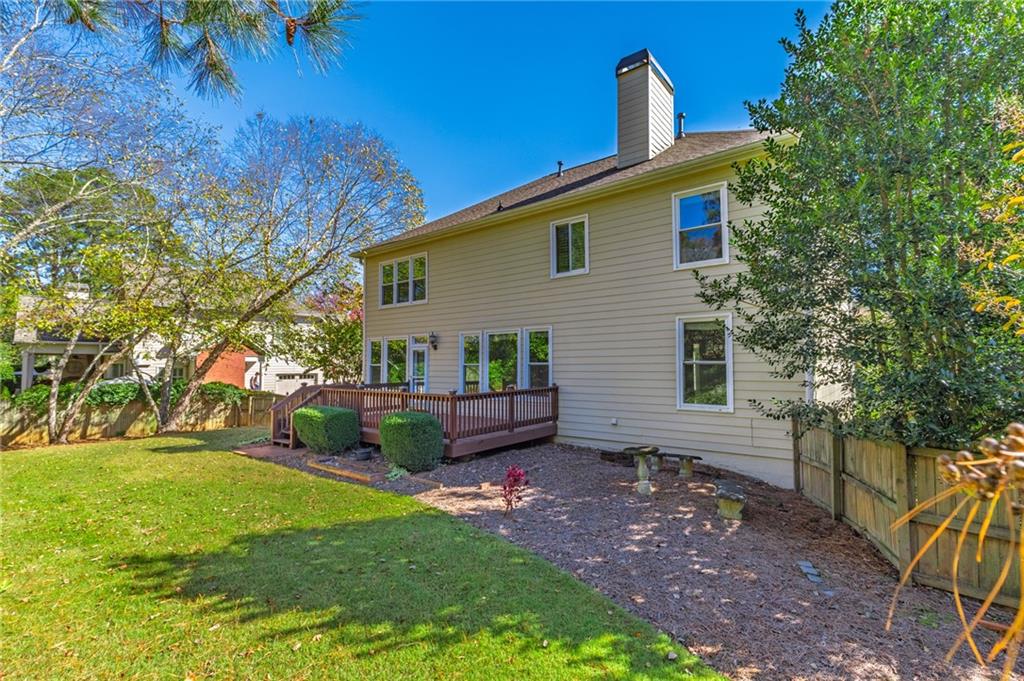 1355 Chattahoochee Run Drive Suwanee, GA 30024 - Photo 42 of 57 a view of a house with backyard and a tree
