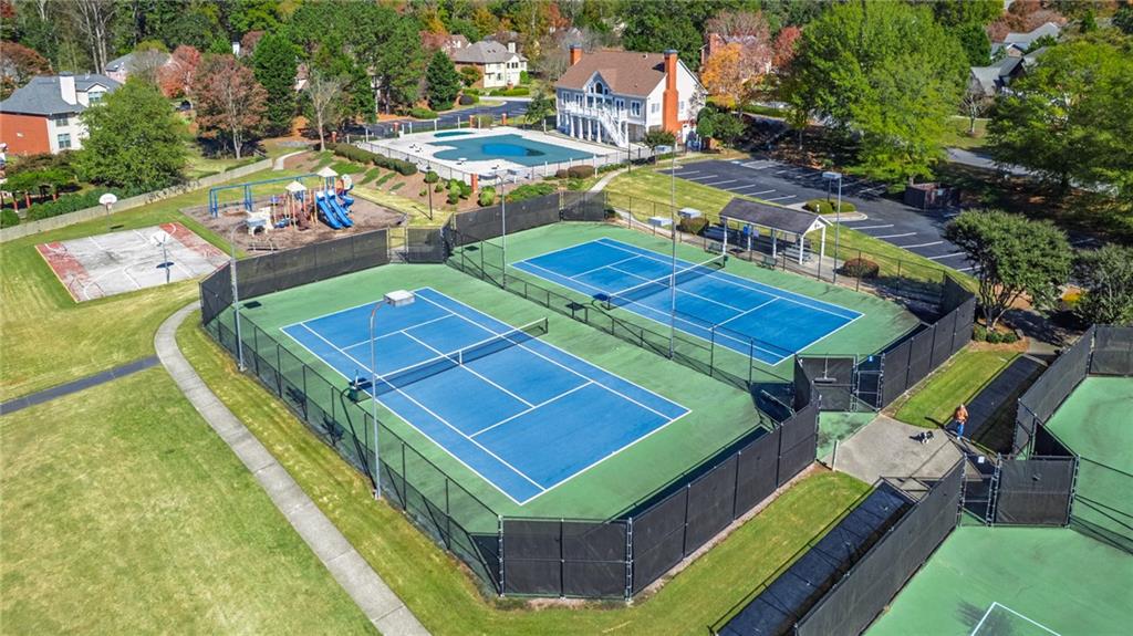 1355 Chattahoochee Run Drive Suwanee, GA 30024 - Photo 53 of 57 a view of a tennis ground with large trees