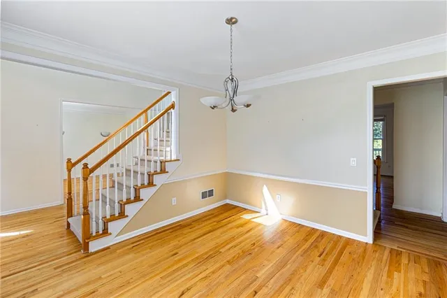 a view of an entryway with wooden floor