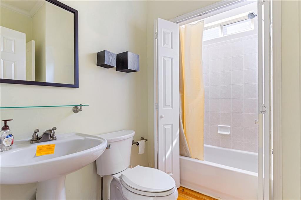 1355 Chattahoochee Run Drive Suwanee, GA 30024 - Photo 7 of 57 a bathroom with a sink and a tub