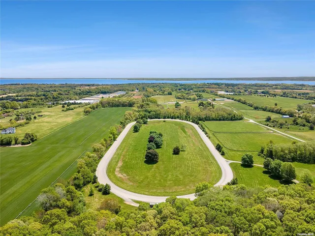 an aerial view of a golf course with a swimming pool
