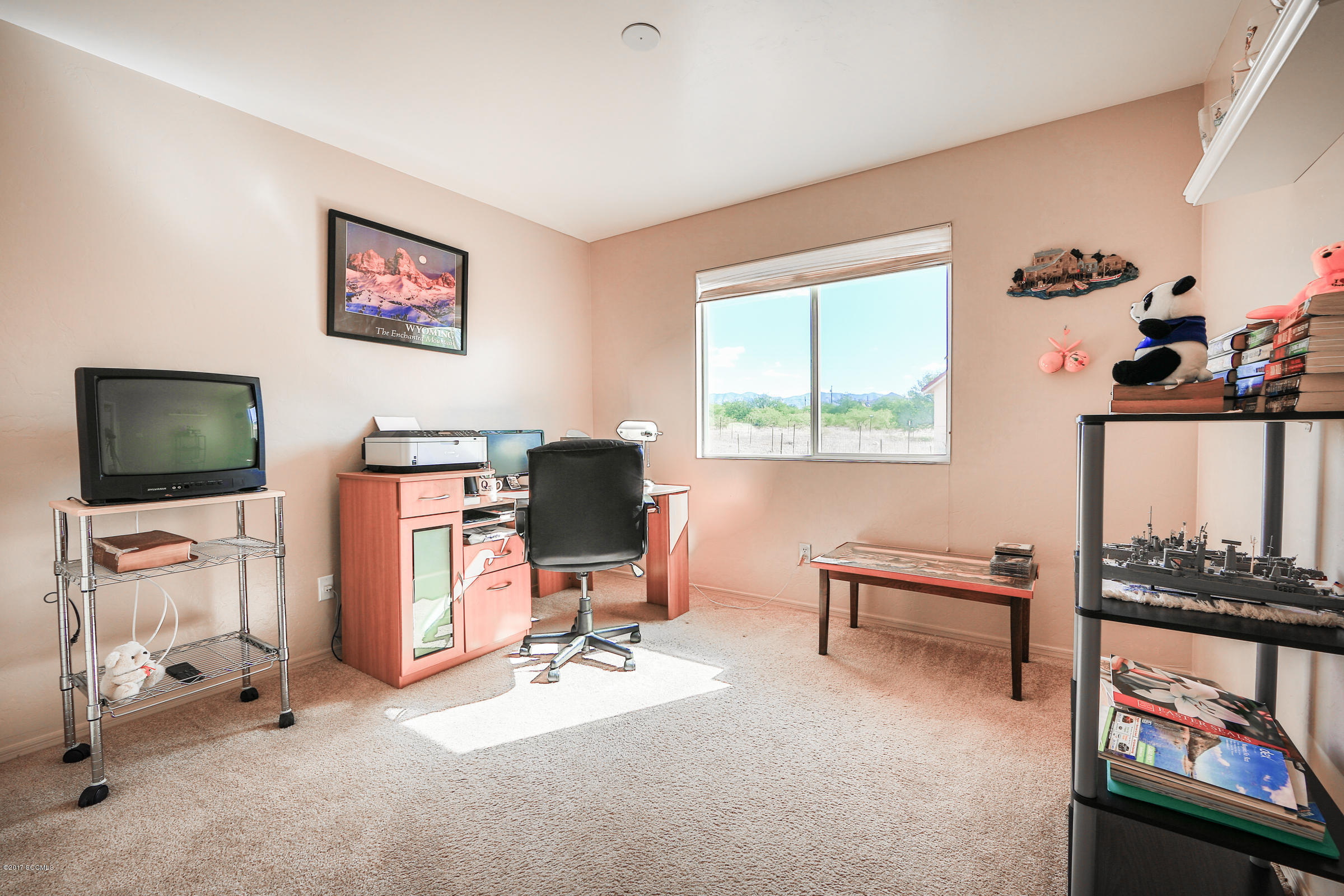 162 Utah Court Rio Rico, AZ 85648 - Photo 13 of 21 a view of a livingroom with workspace and a window