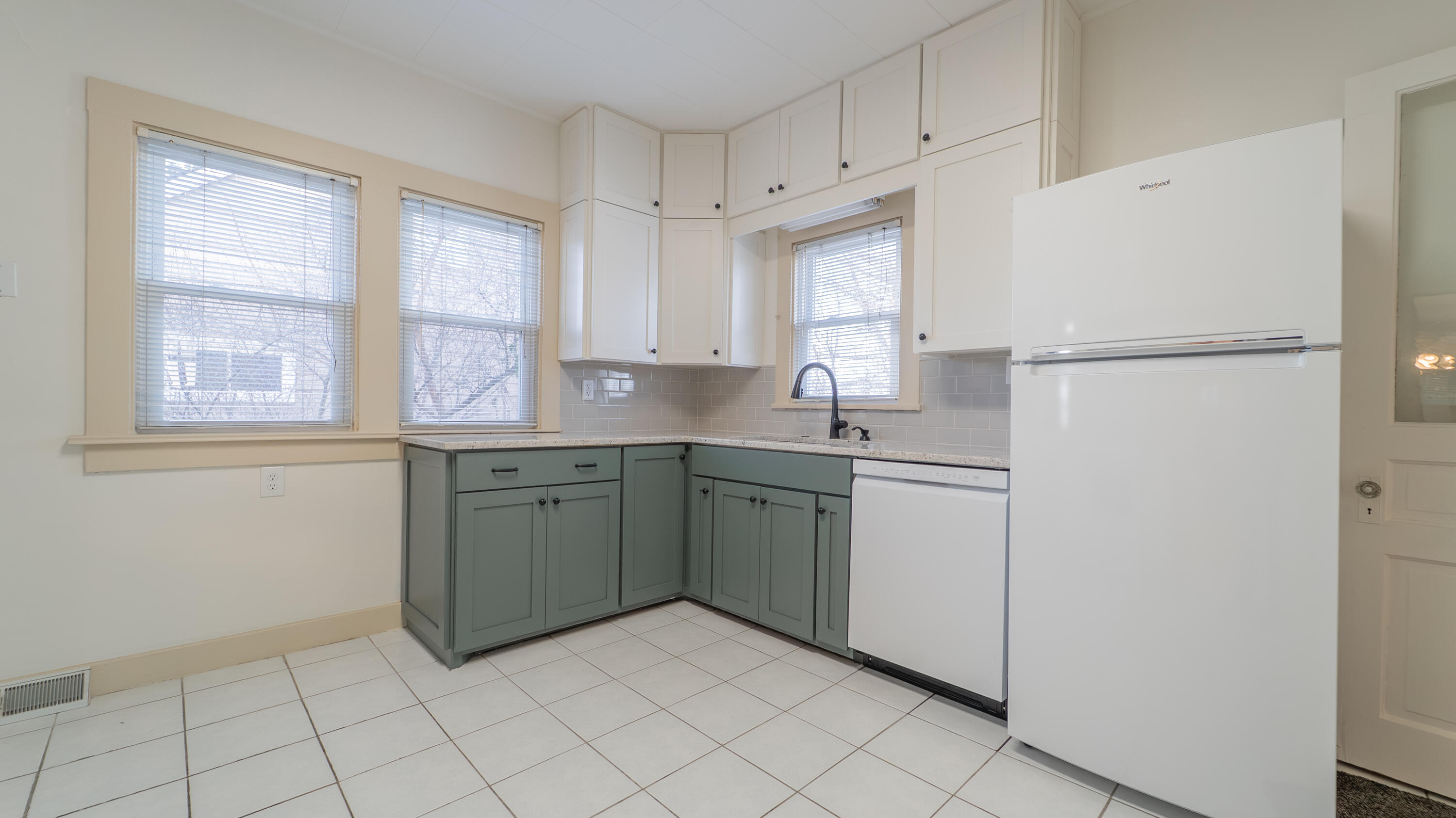 1013 Merrillville Road Crown Point, IN 46307 - Photo 16 of 36 a kitchen with a refrigerator sink and cabinets