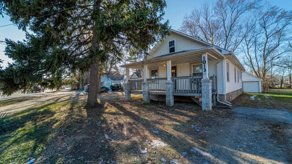 a view of a house with a yard covered in snow