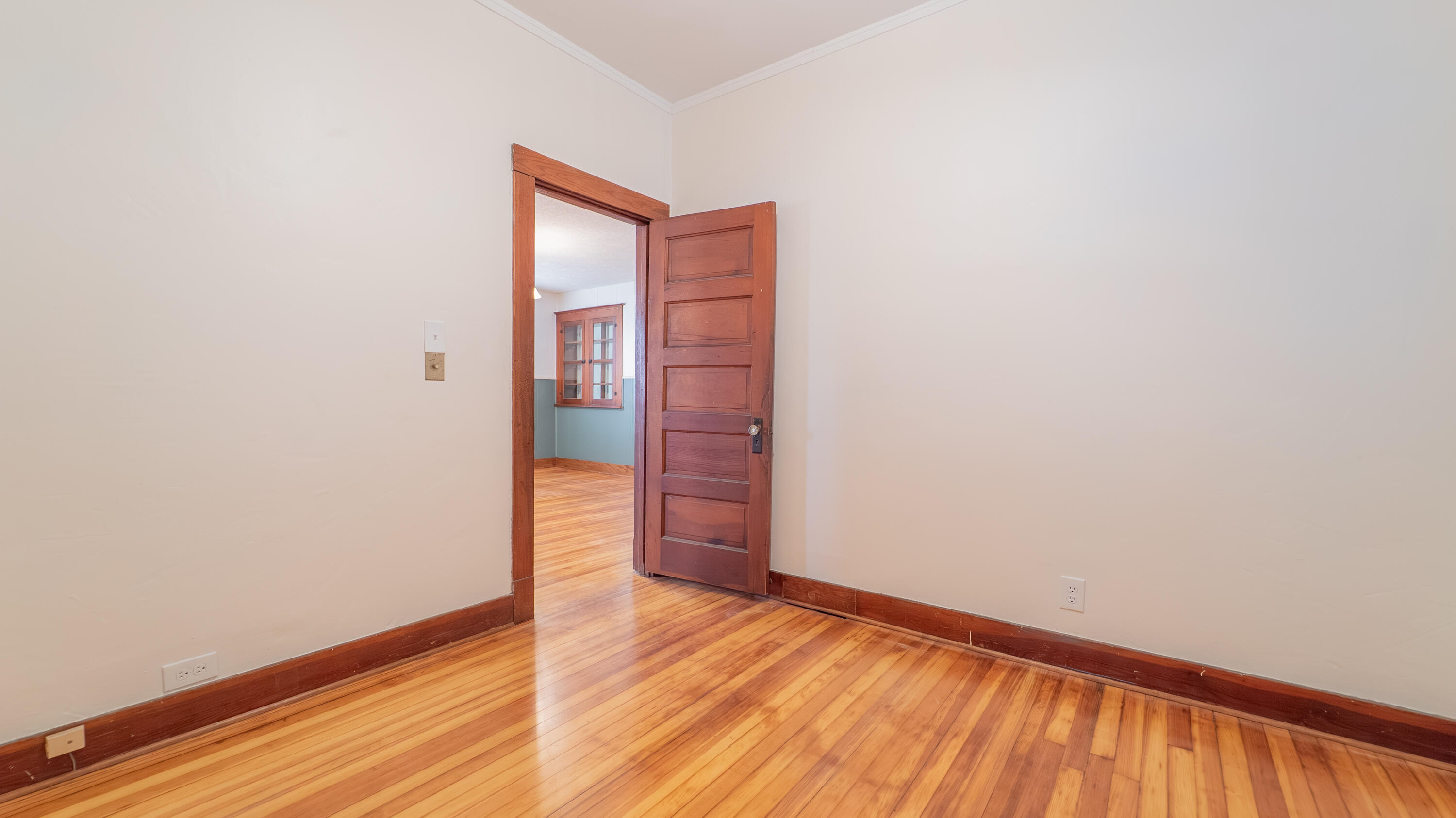 1013 Merrillville Road Crown Point, IN 46307 - Photo 22 of 36 a view of an empty room with wooden floor and a window