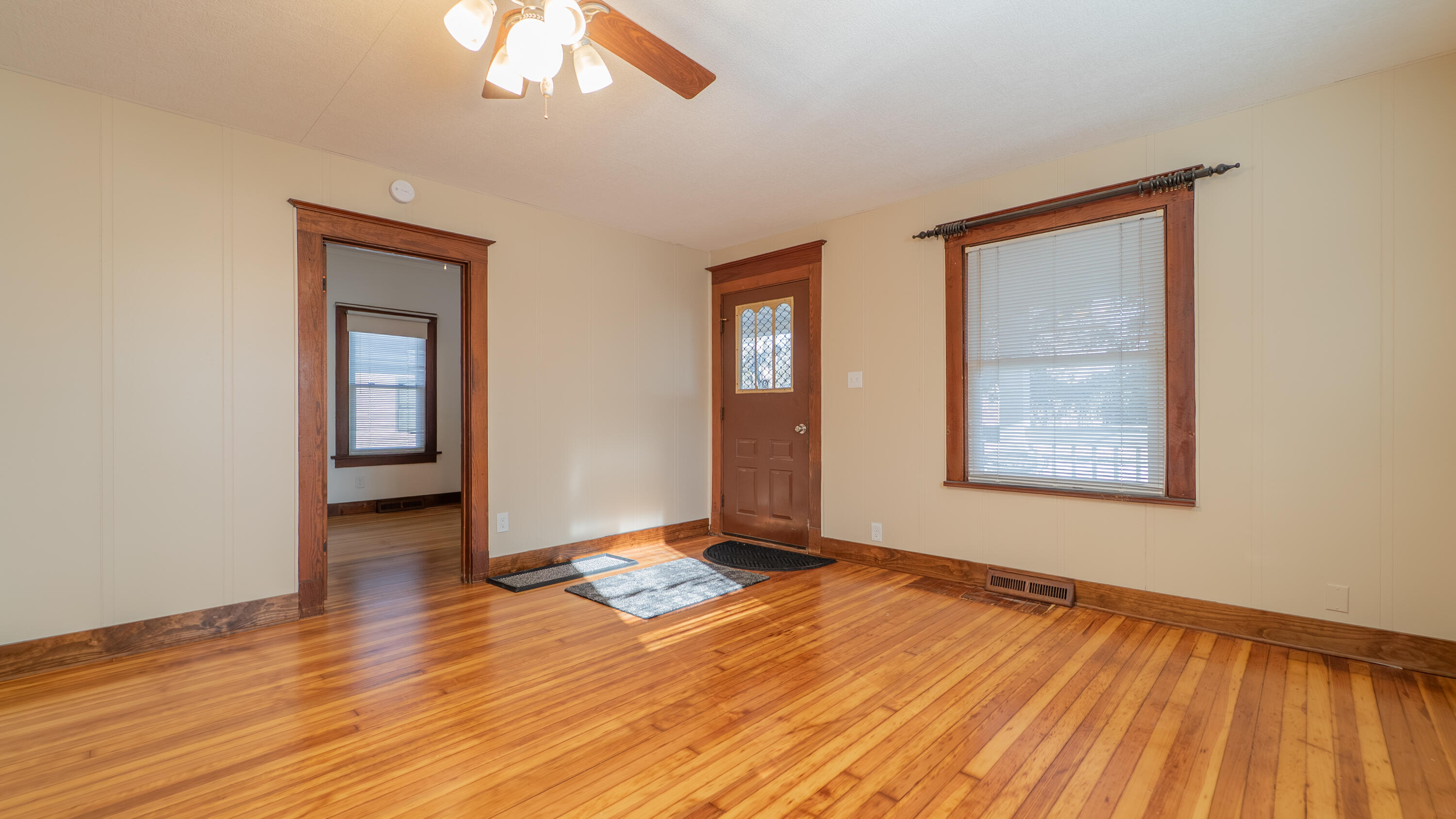 1013 Merrillville Road Crown Point, IN 46307 - Photo 5 of 36 a view of an empty room with wooden floor and a window
