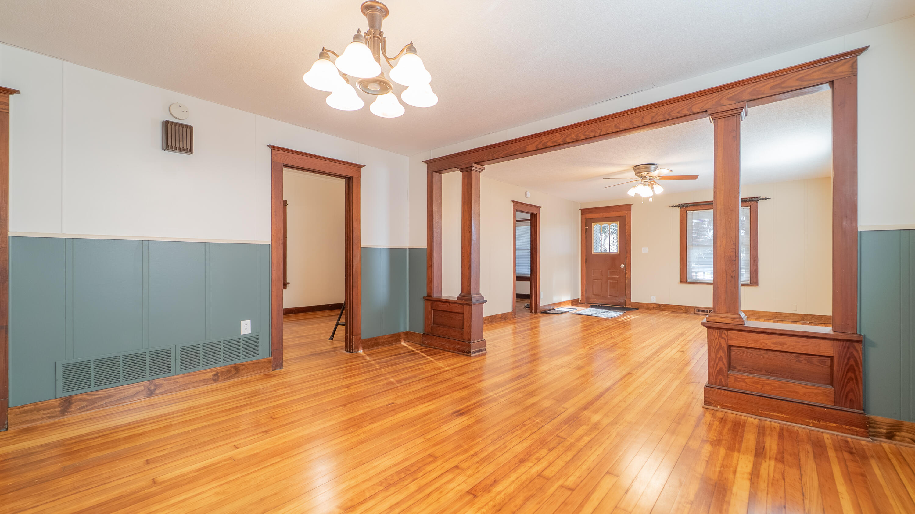 1013 Merrillville Road Crown Point, IN 46307 - Photo 9 of 36 a view of an empty room with wooden floor and a ceiling fan
