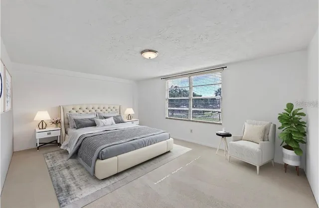 a spacious bedroom with a bed and a couch