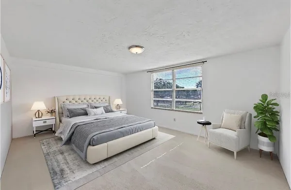 a spacious bedroom with a bed and a couch