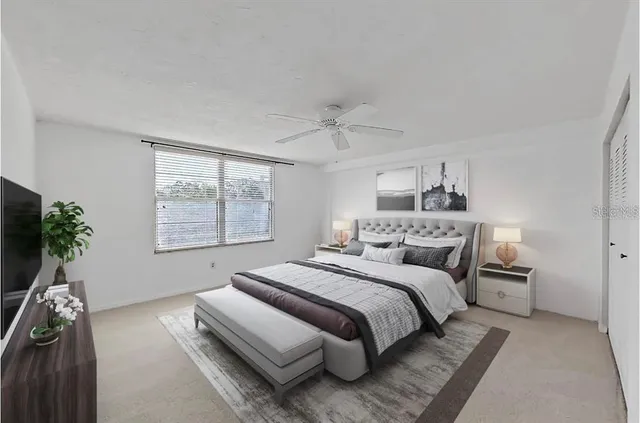 a bedroom with a bed and a potted plant