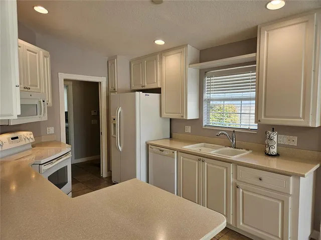 a kitchen with a sink appliances and cabinets