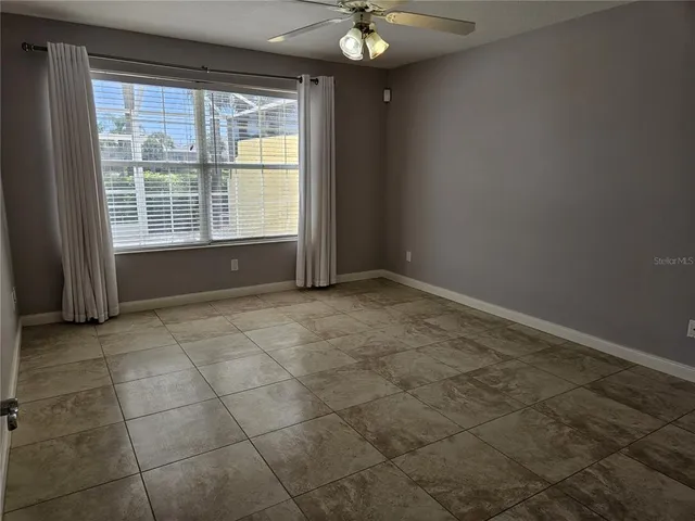 an empty room with a mirror and a window