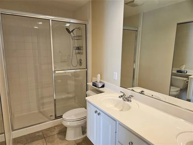 a spacious bathroom with a double vanity sink a mirror and a bathtub