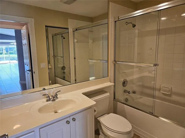 a bathroom with a shower and a sink