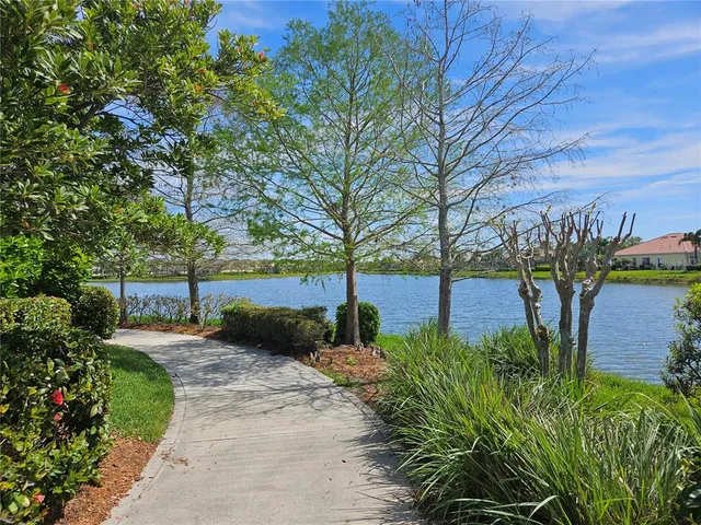 a front view of a house with garden and lake view