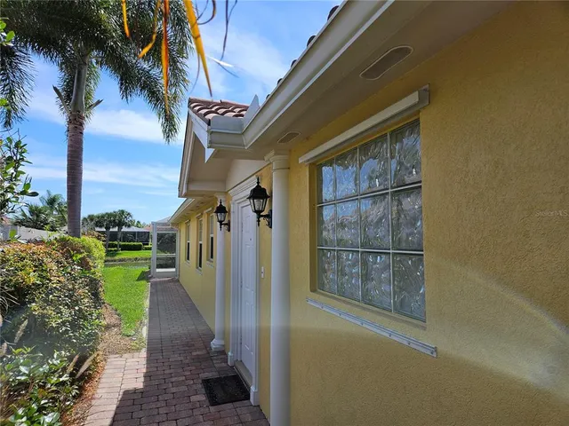 a view of a pathway of a building with a yard