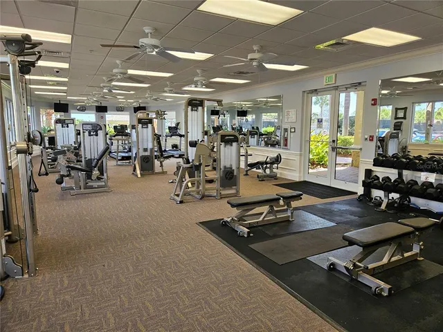 a room with gym equipment and a large window
