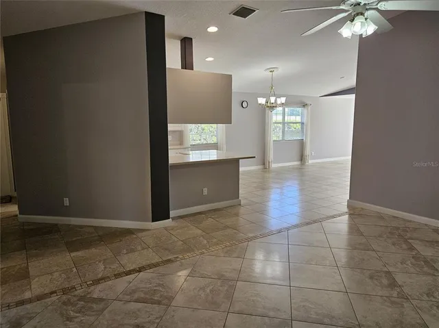 a view of kitchen with livingroom and chandelier