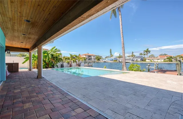a view of a patio with a table and chairs under an umbrella