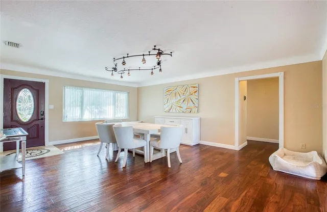 a view of a dining room with furniture window and wooden floor