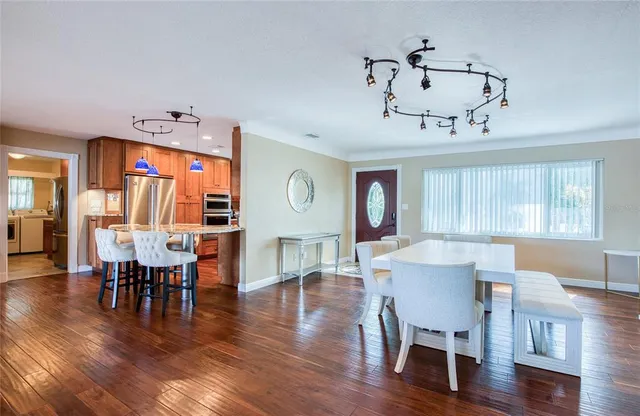 a large kitchen with a table and chairs