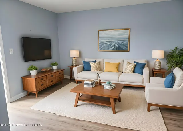 a living room with furniture and a flat screen tv