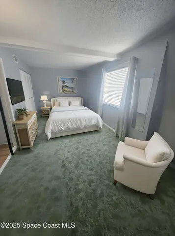 a spacious bedroom with a bed and a couch