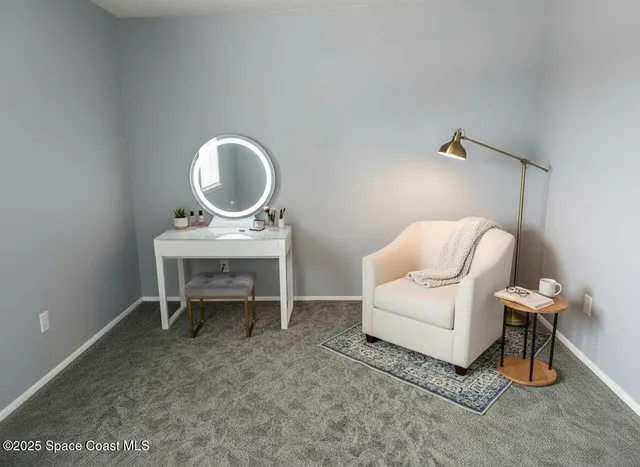 a work room with furniture and a mirror