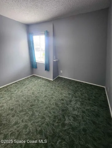 a bedroom with a bed and flat screen tv