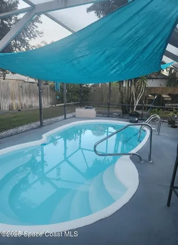 a view of a swimming pool with a patio