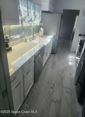 a bathroom with a sink a mirror and a shower