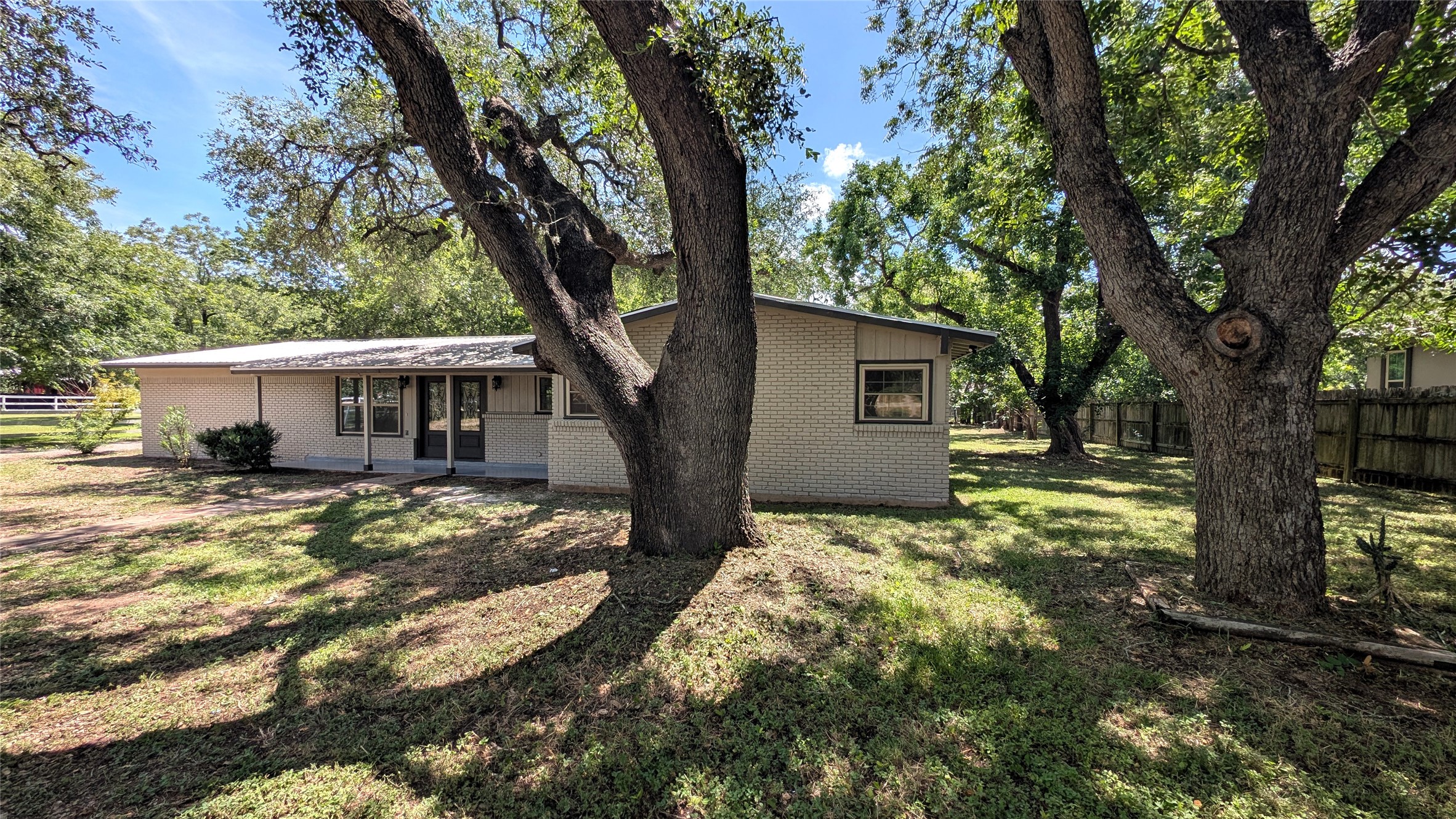 11811 Sleepy Hollow Road Manchaca, TX 78652 - Photo 3 of 31 a view of a house with a tree in the forest
