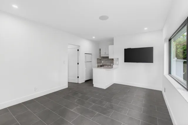 a view of kitchen with microwave cabinets and refrigerator