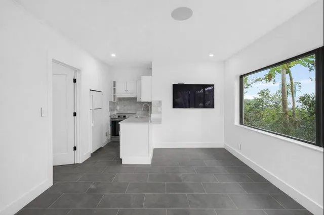 a view of a kitchen with white cabinets