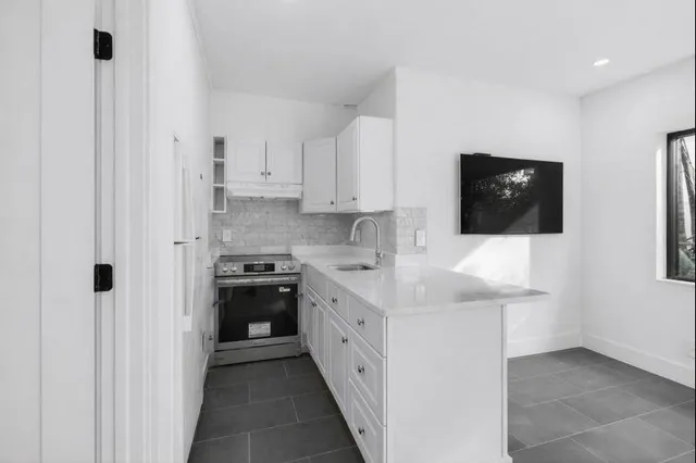 a kitchen with stainless steel appliances a stove microwave and refrigerator