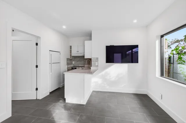 a kitchen with stainless steel appliances a refrigerator and a stove top oven