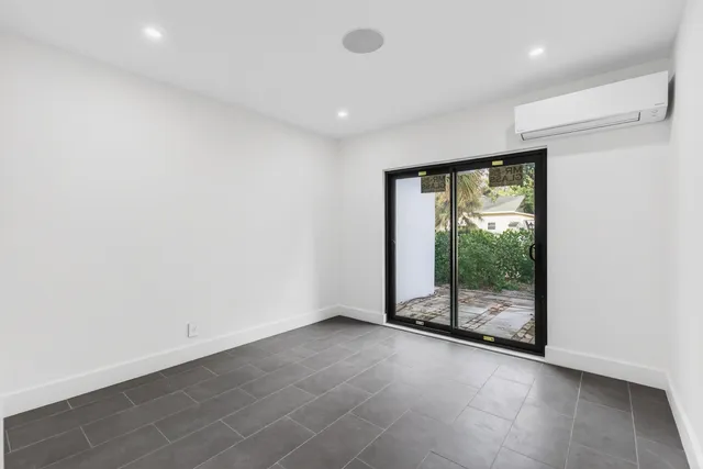 an empty room with sliding glass door and mountain view