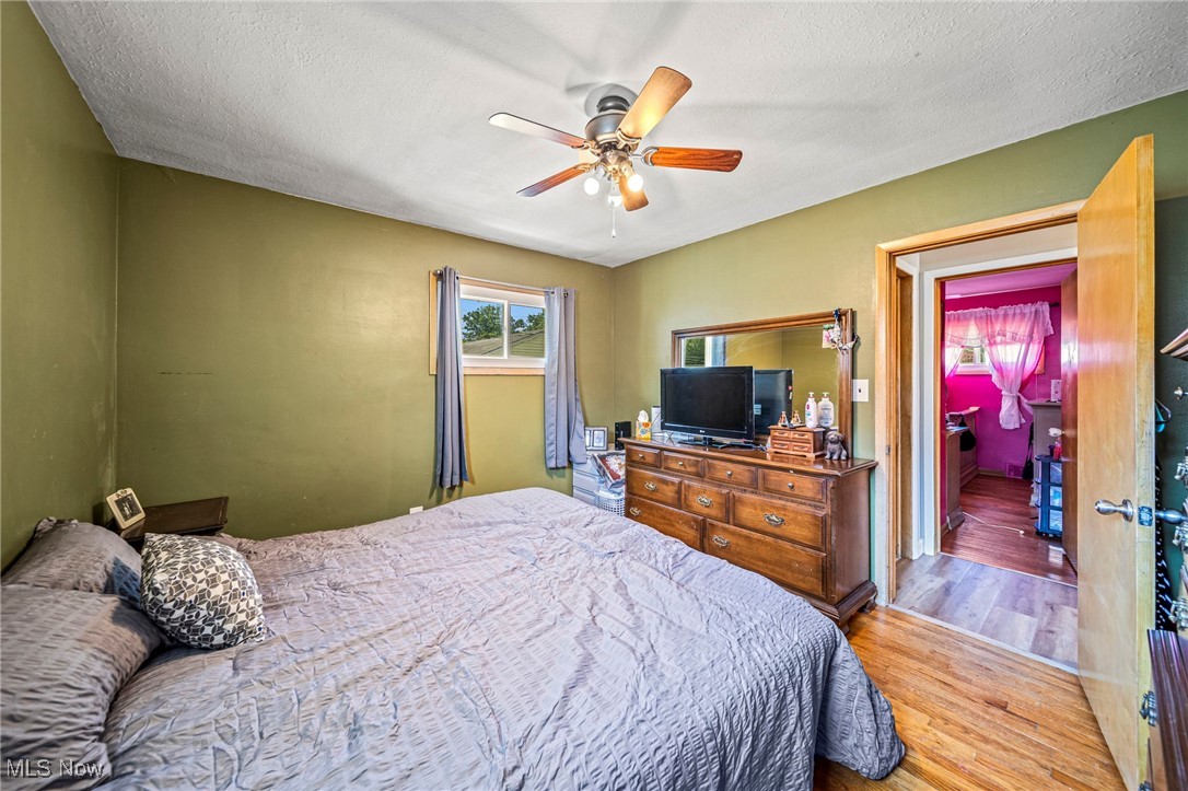 28666 Forest Road Willowick, OH 44095 - Photo 15 of 27 Bedroom featuring wood finished floors, ceiling fan, and a textured ceiling