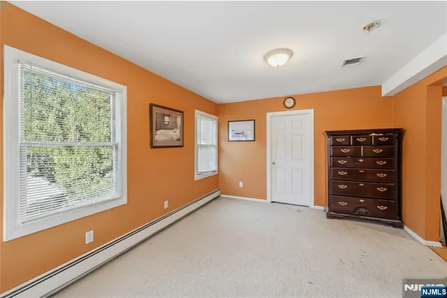 an empty room with windows and closet