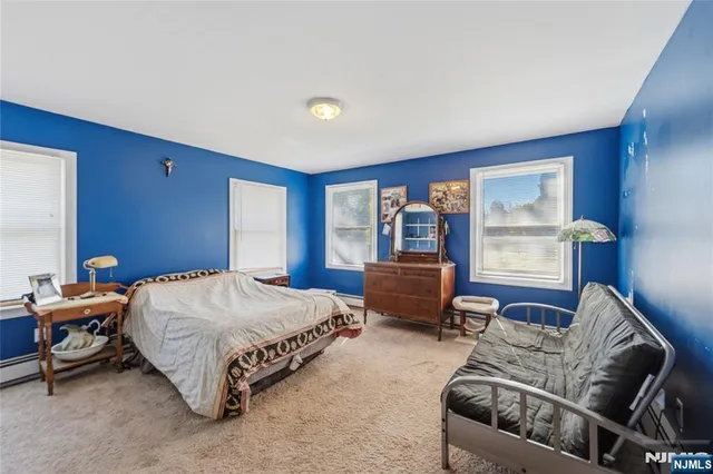 a bedroom with a bed and dresser