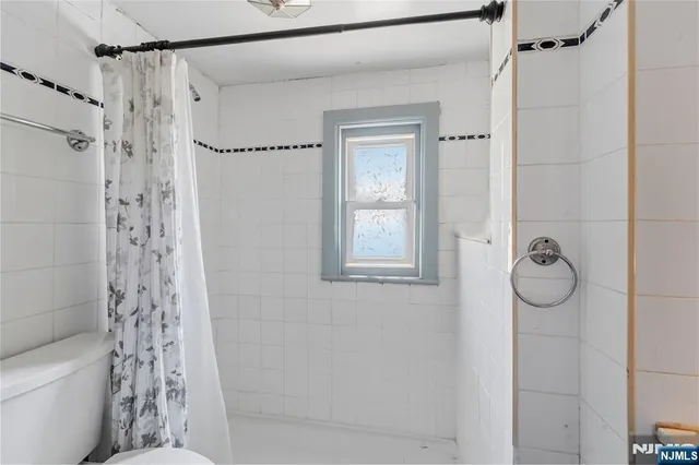 a bathroom with a shower a toilet and a shower