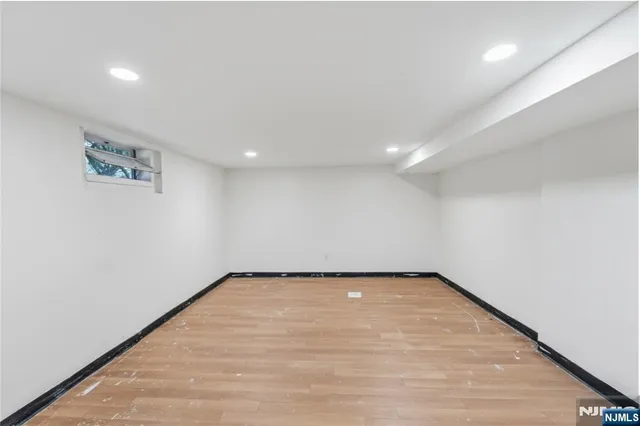 a view of a room with wooden floor and window