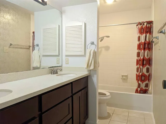 a utility room with cabinet dryer and washer