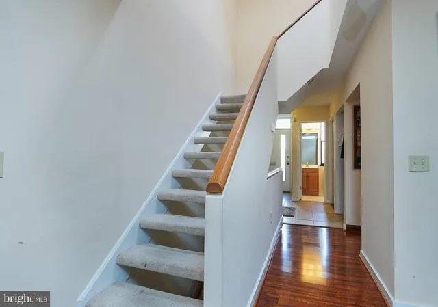 a view of entryway and gallery with wooden floor