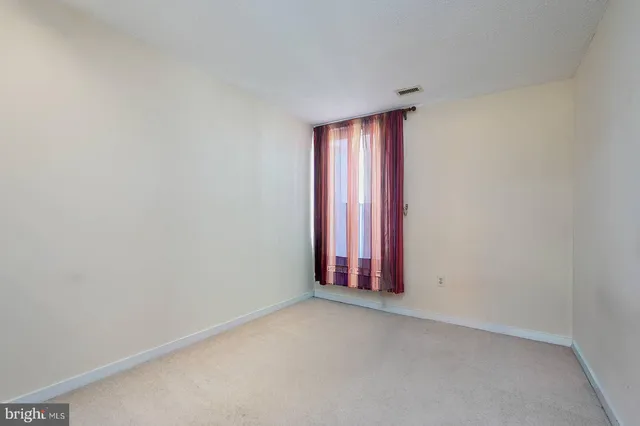 a view of wooden floor and red carpet in a room