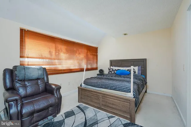 a bedroom with two beds and a couch