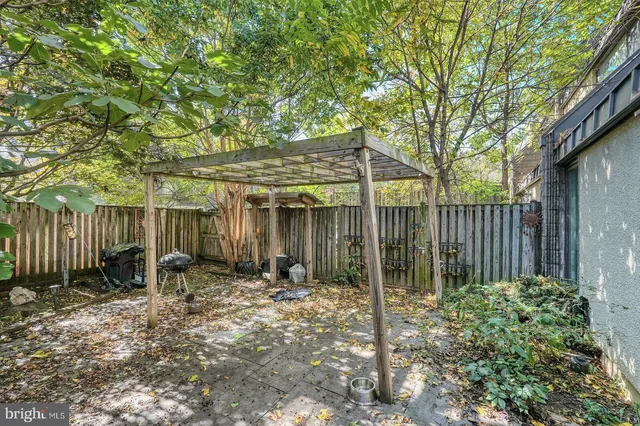 a backyard of a house with table and chairs