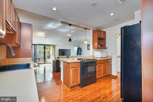 a kitchen with stainless steel appliances granite countertop a stove and a refrigerator
